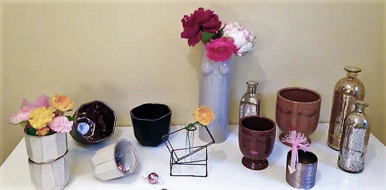 an array of specialty bottles, pots and vases